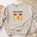 a sweatshirt with two burritos on it