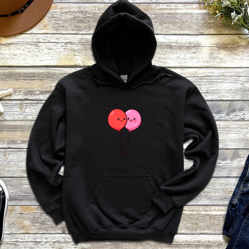 a black hoodie with two pink balloons on it