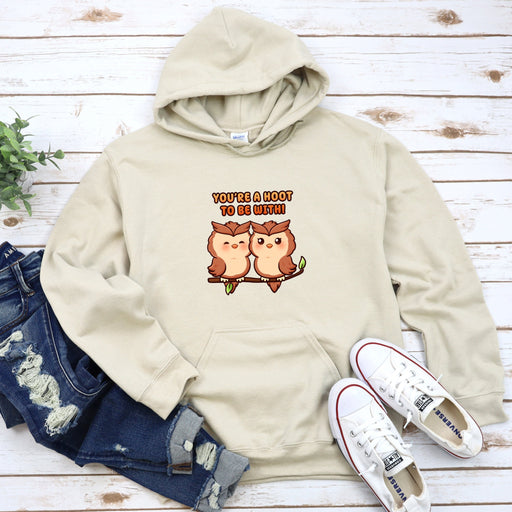 a pair of owls sitting on top of a white hoodie