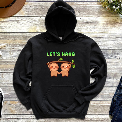 a black hoodie with two slots hanging on a tree