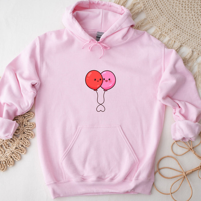 a pink hoodie with two balloons drawn on it