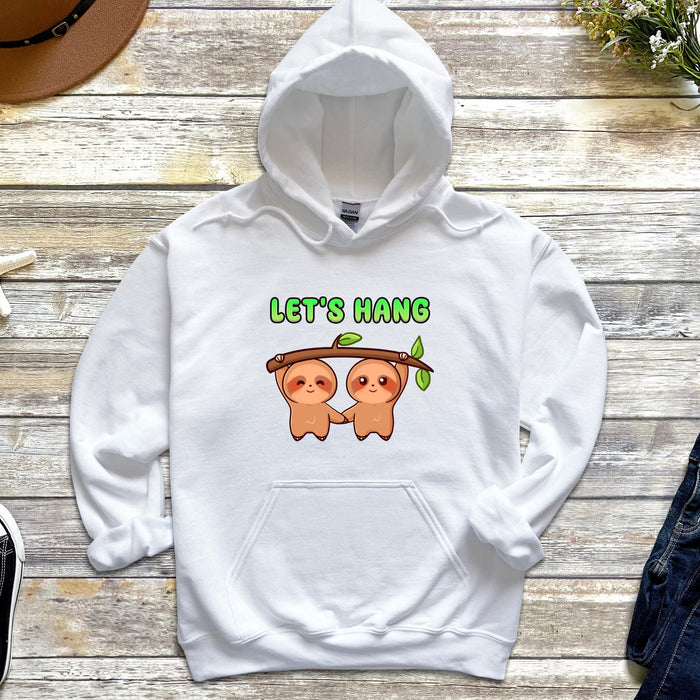 a white hoodie with two slots hanging from a tree