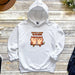 a couple of owls sitting on top of a white hoodie