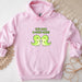 a pink hoodie with two green birds on it