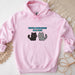 a pink hoodie with two cats on it