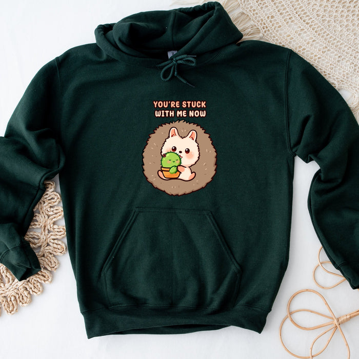 a green sweatshirt with a hedge holding a turtle