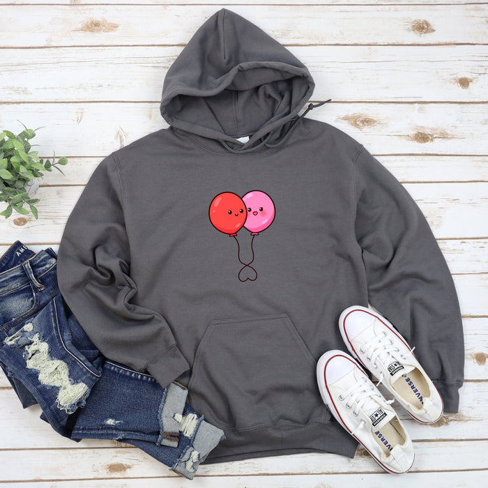 a pair of shoes and a sweatshirt on a wooden surface