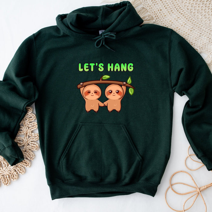 a green sweatshirt with two slots hanging on a tree branch
