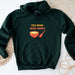 a green sweatshirt with a bowl of soup on it