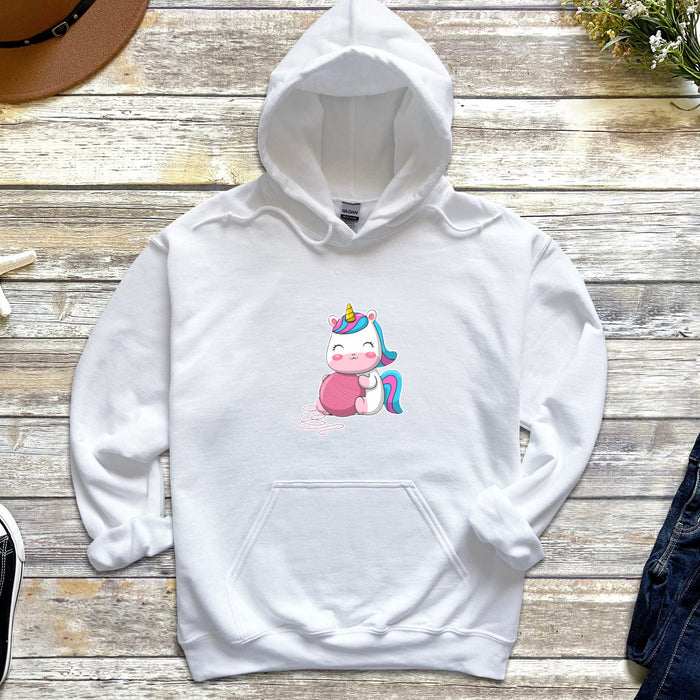 a white hoodie with a unicorn on it