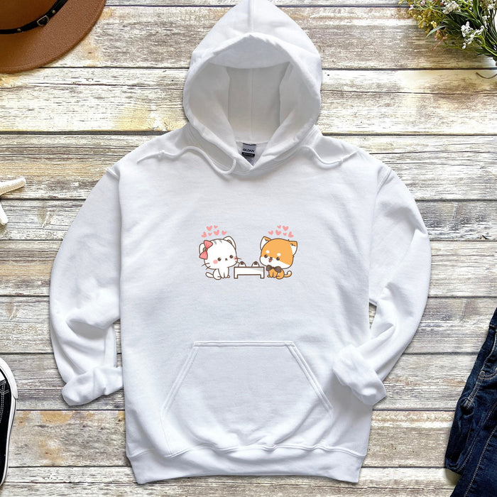 a white hoodie with a cat and dog on it