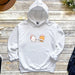 a white hoodie with a cat and dog on it