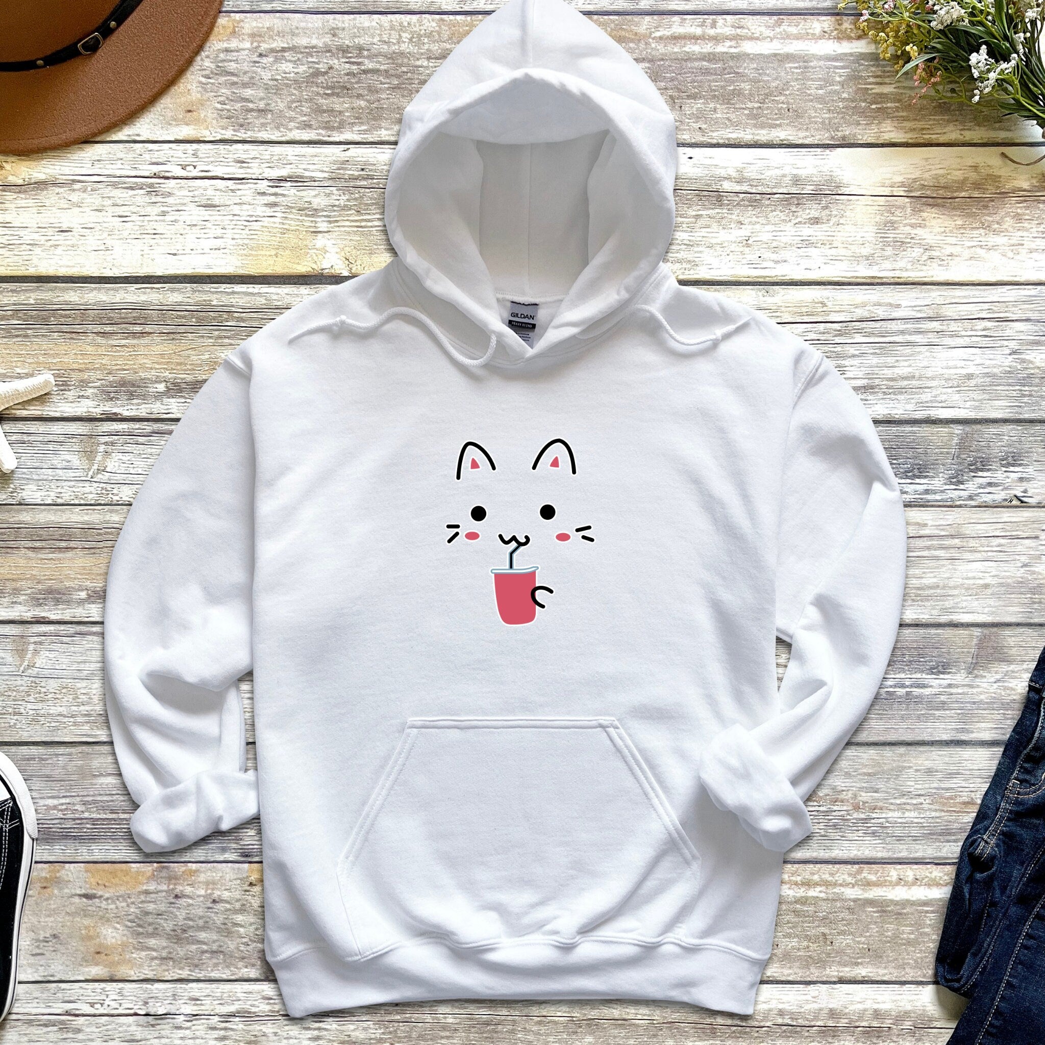 a white hoodie with a cat face drawn on it
