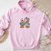 a pink hoodie with a cartoon cat eating pizza