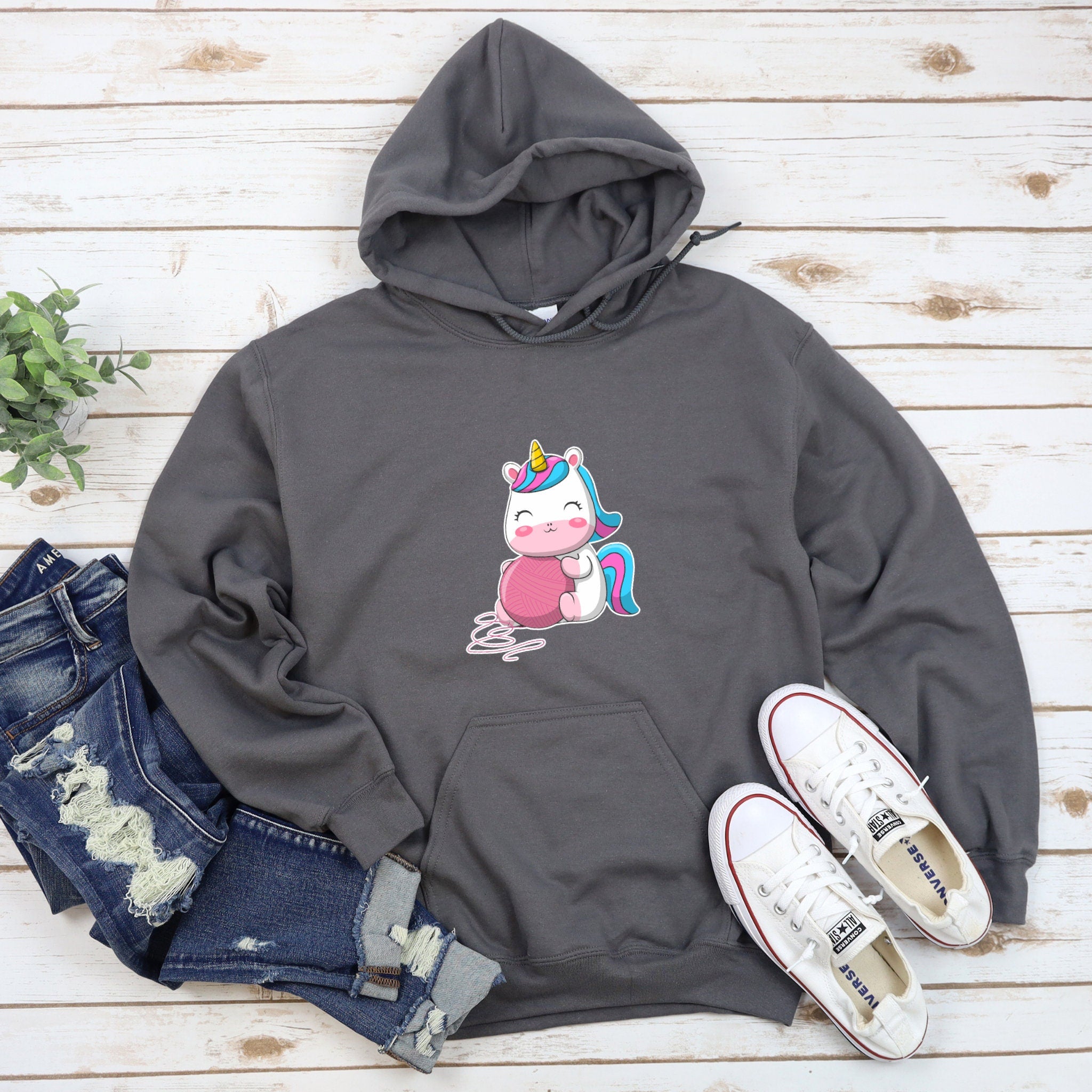 a sweatshirt with a unicorn on it and a pair of jeans