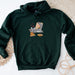 a green hoodie with an image of a cat eating pizza