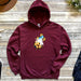 a maroon hoodie with a cartoon character on it