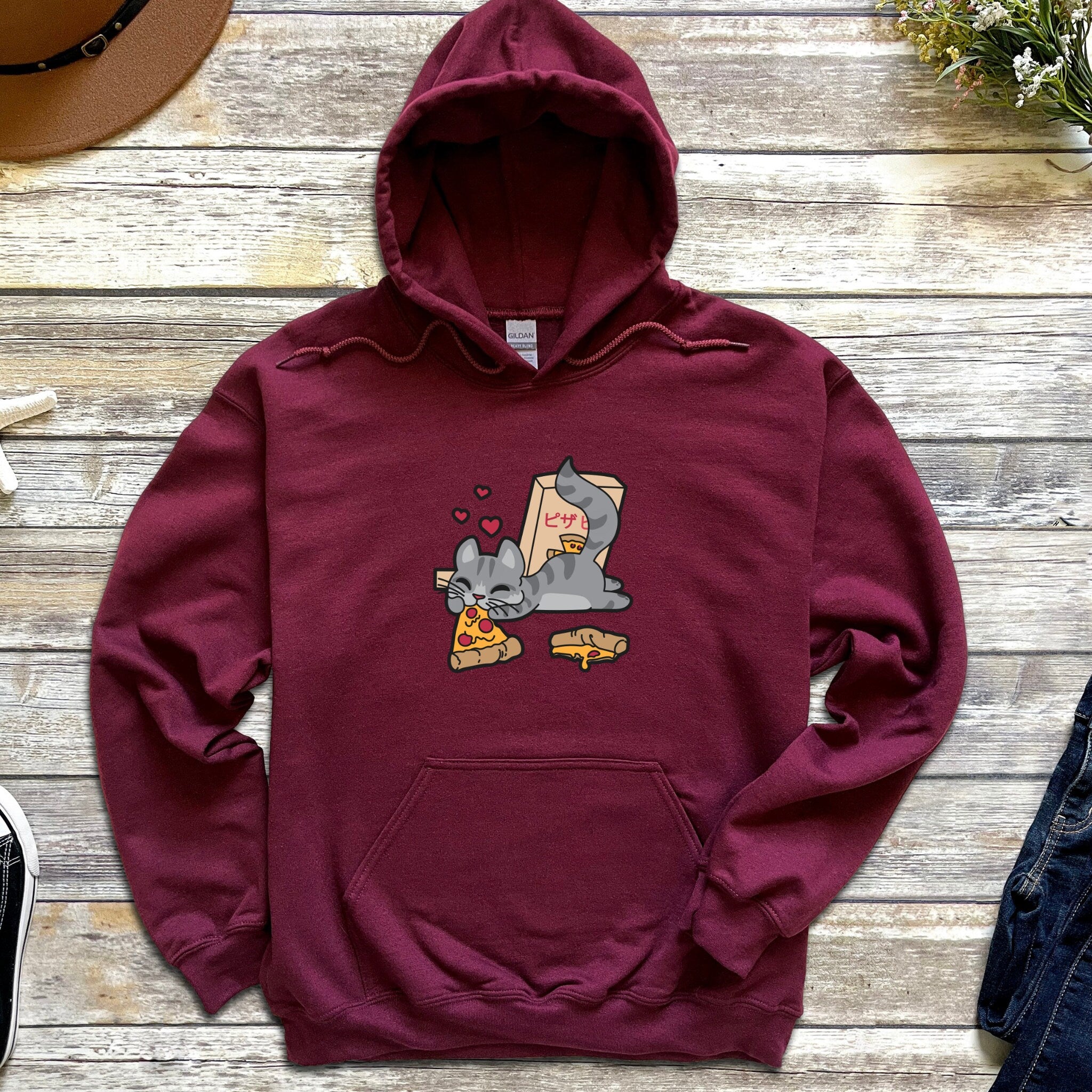 a maroon hoodie with a cartoon cat on it