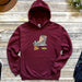 a maroon hoodie with a cartoon cat on it