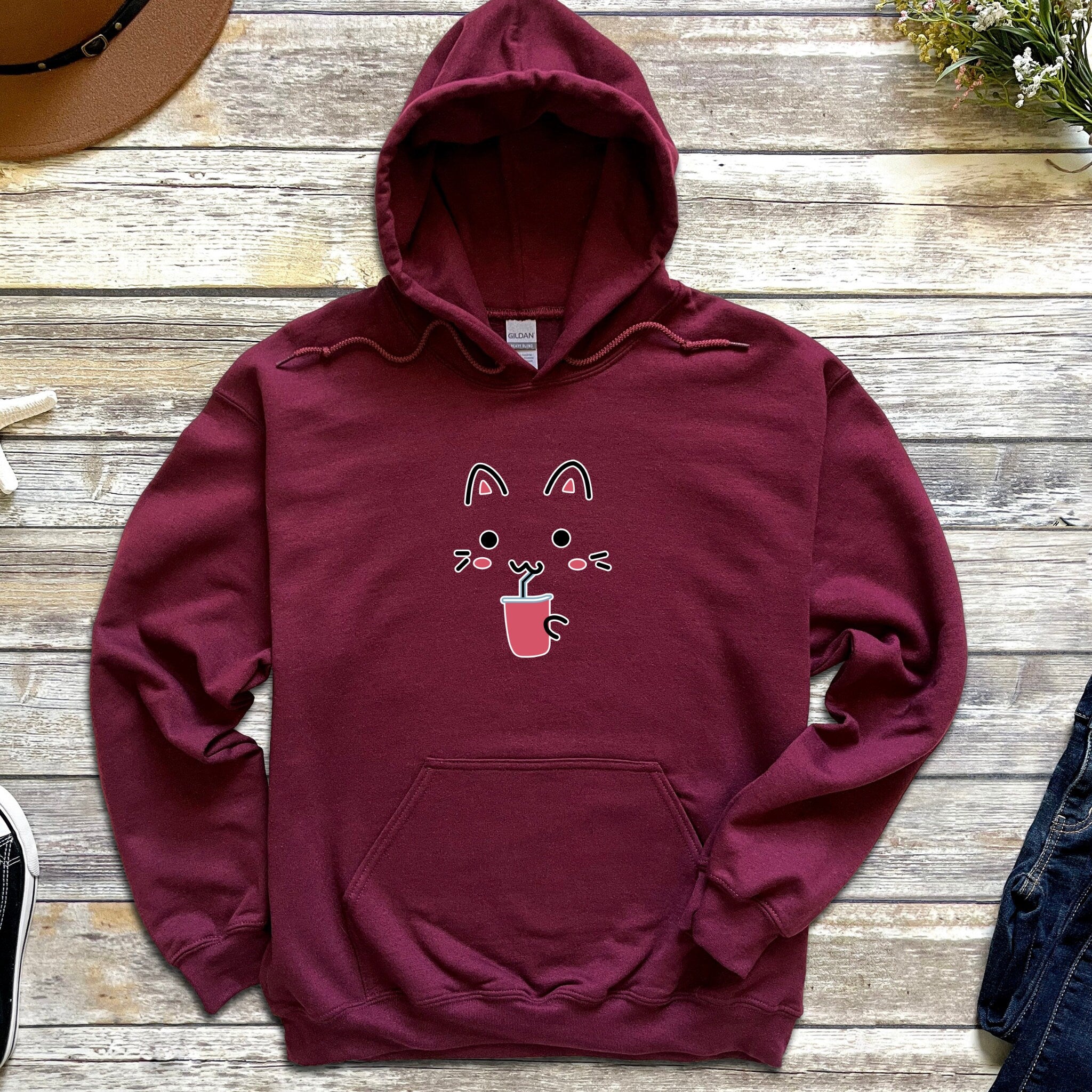 a maroon hoodie with a cat on it