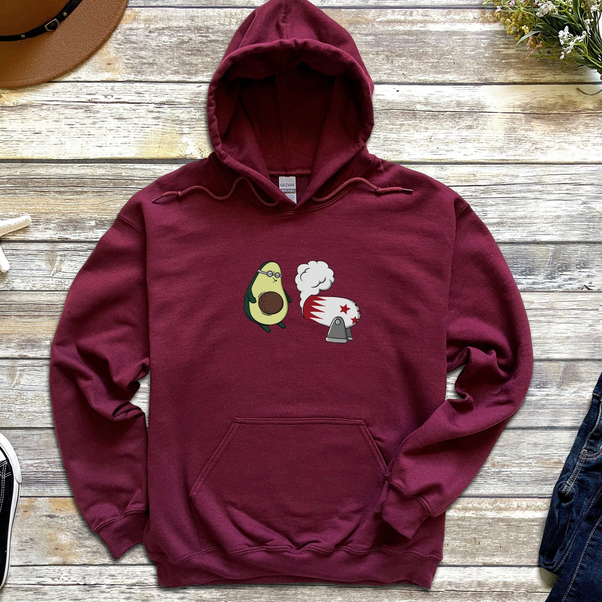 a maroon sweatshirt with an avocado on it