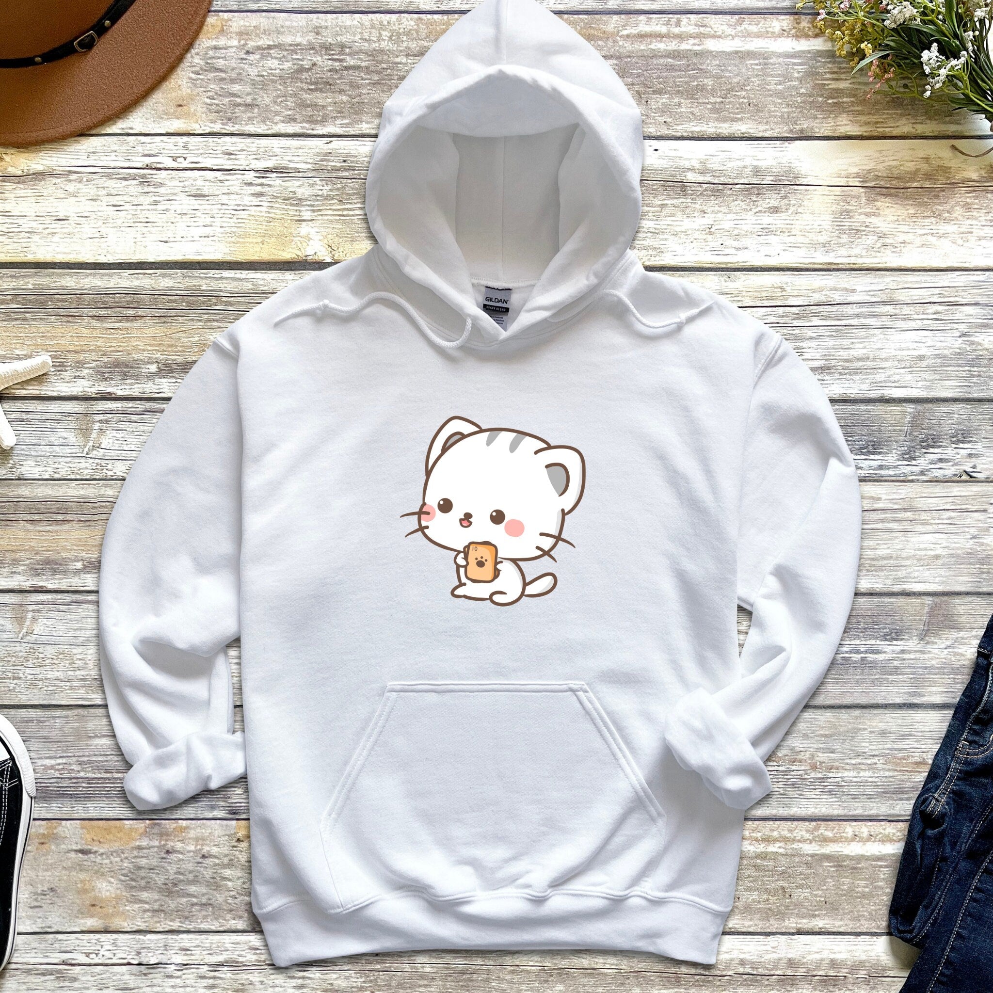 a white hello kitty hoodie with a coffee cup on it