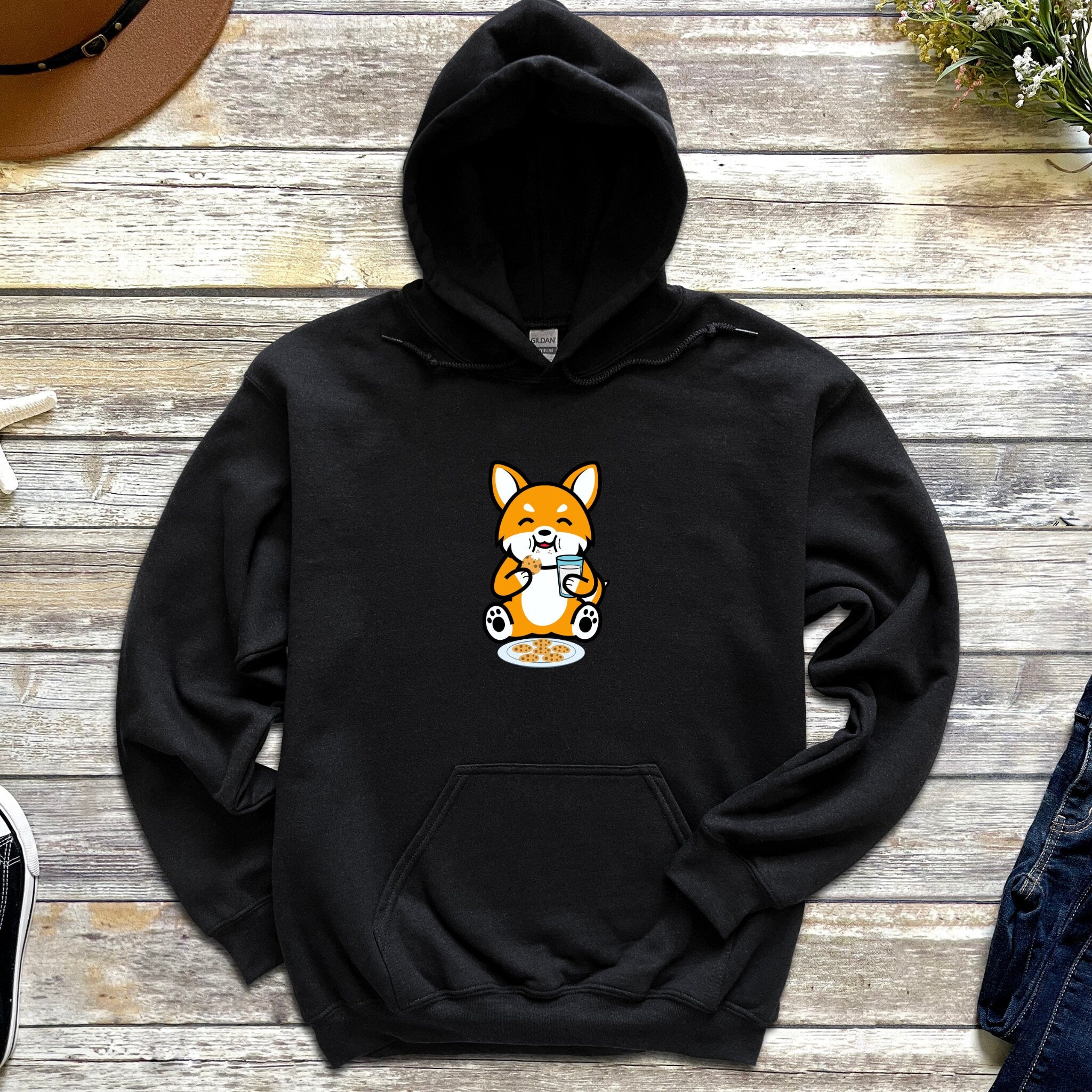 a black hoodie with a picture of a corgi on it
