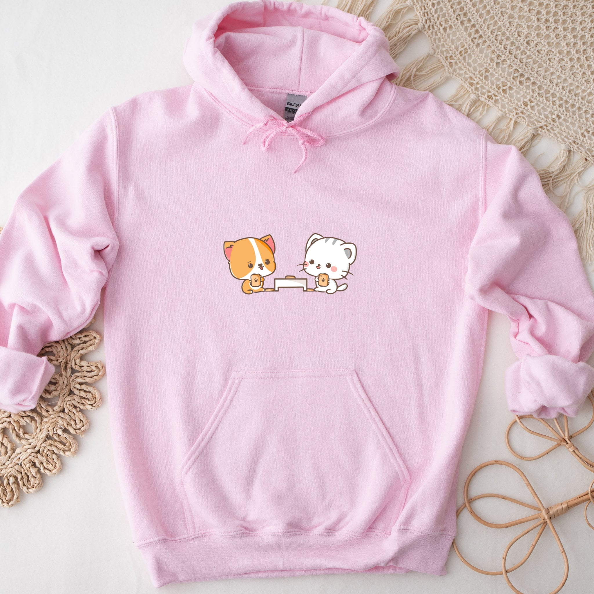 a pink hoodie with a picture of a cat and a dog on it