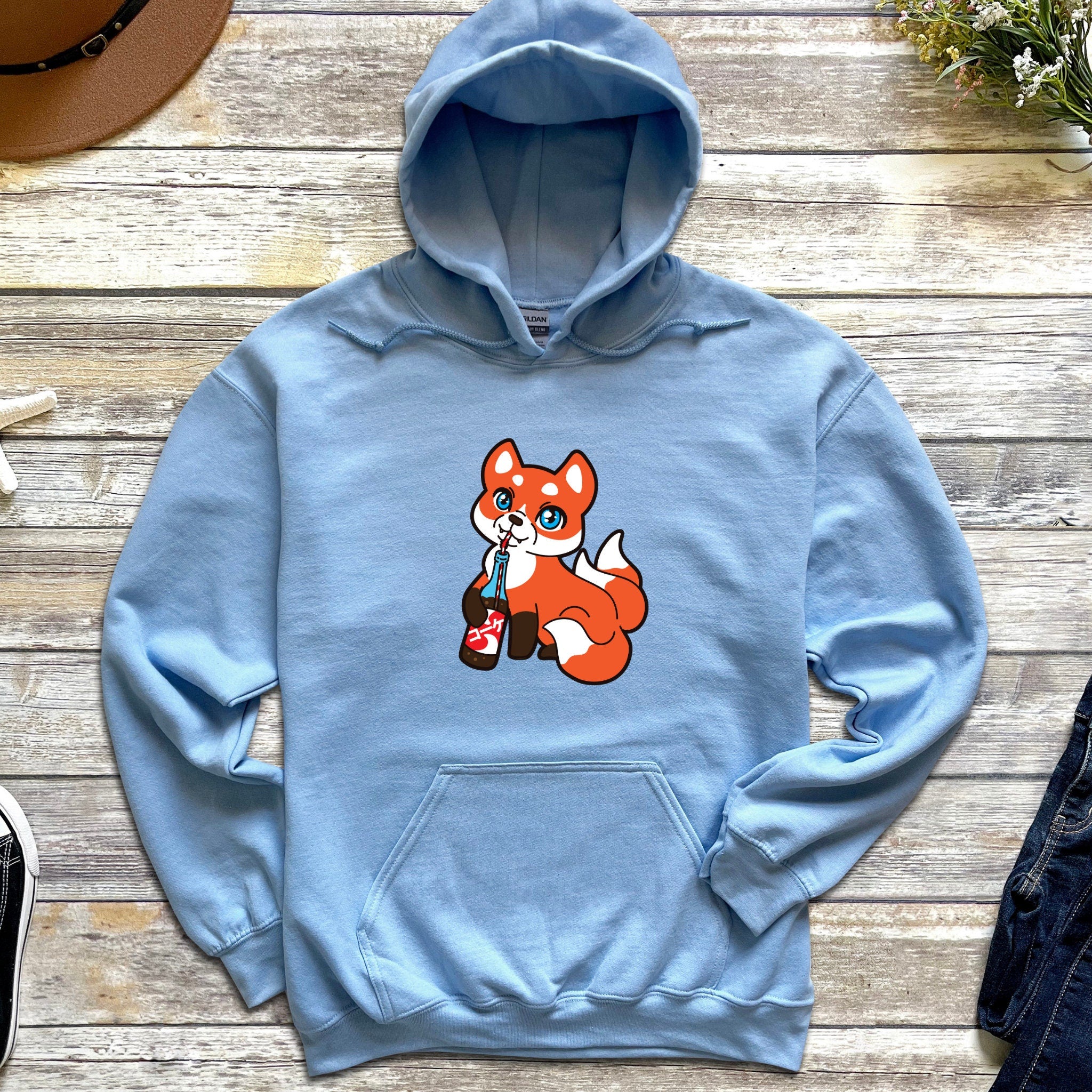 a blue hoodie with a cartoon fox on it