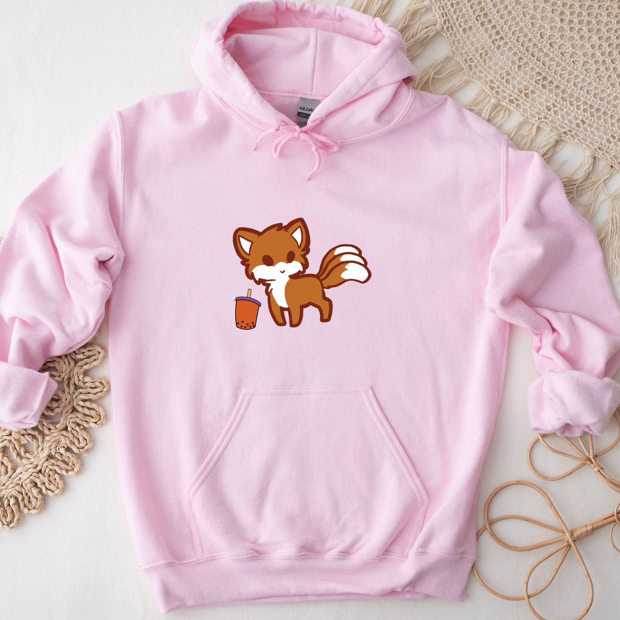 a pink hoodie with a cartoon fox on it