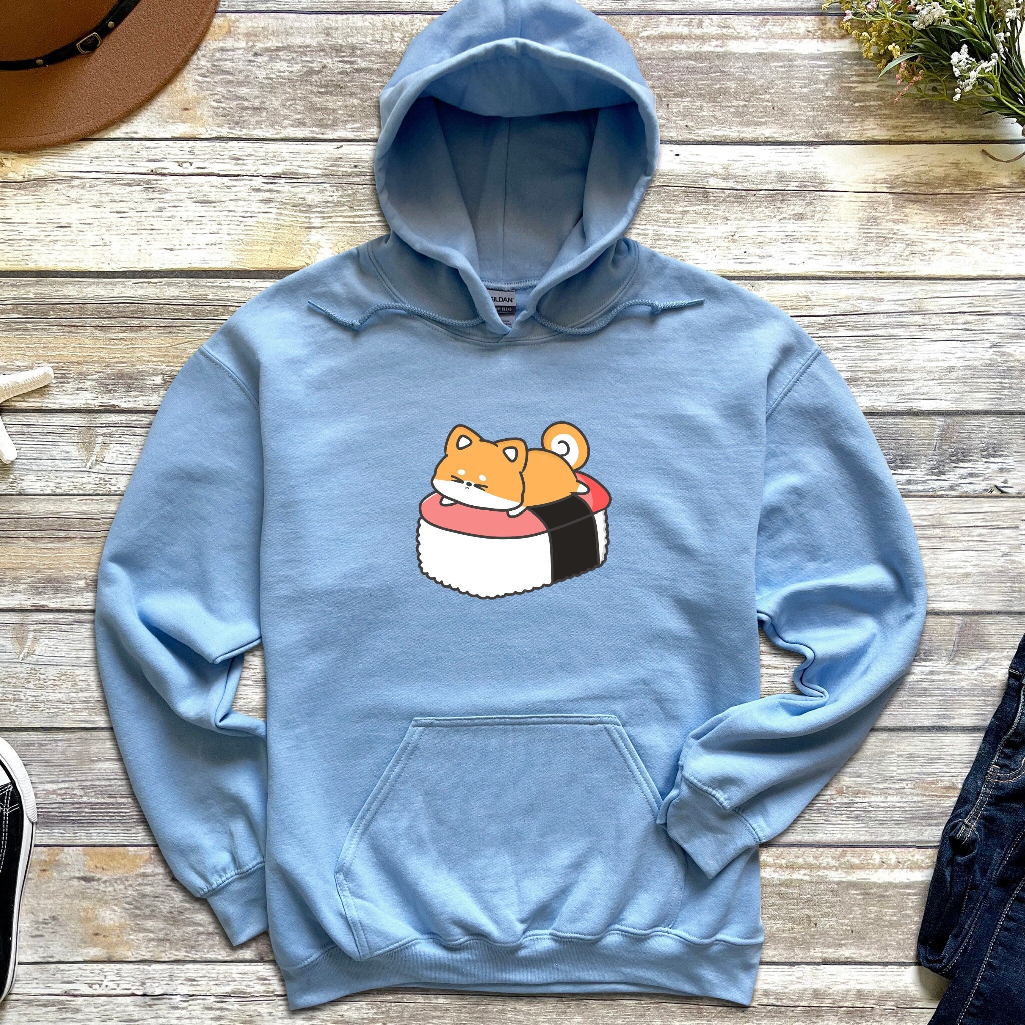 a blue hoodie with a sushi character on it