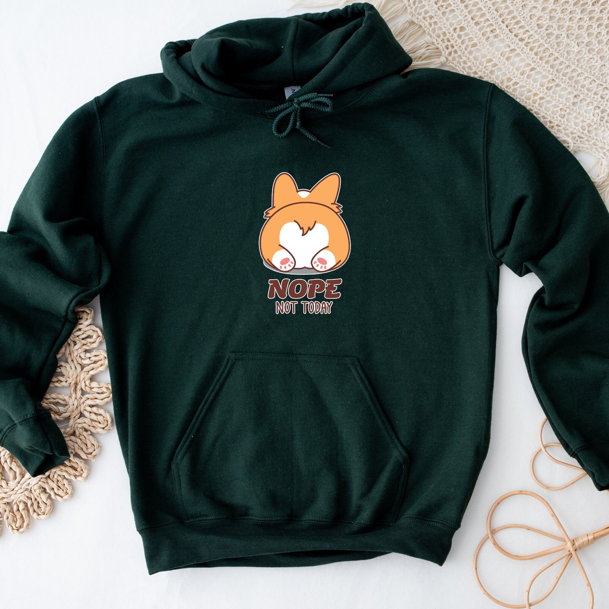 a green hoodie with a cartoon fox on it