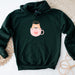 a green sweatshirt with a coffee cup on it