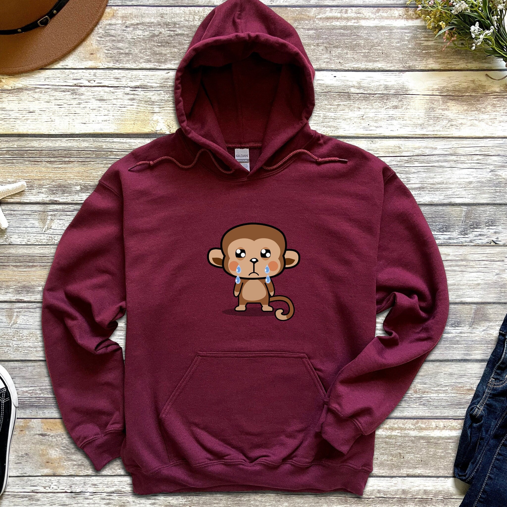 a maroon hoodie with a monkey on it