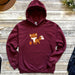 a maroon hoodie with a picture of a fox on it