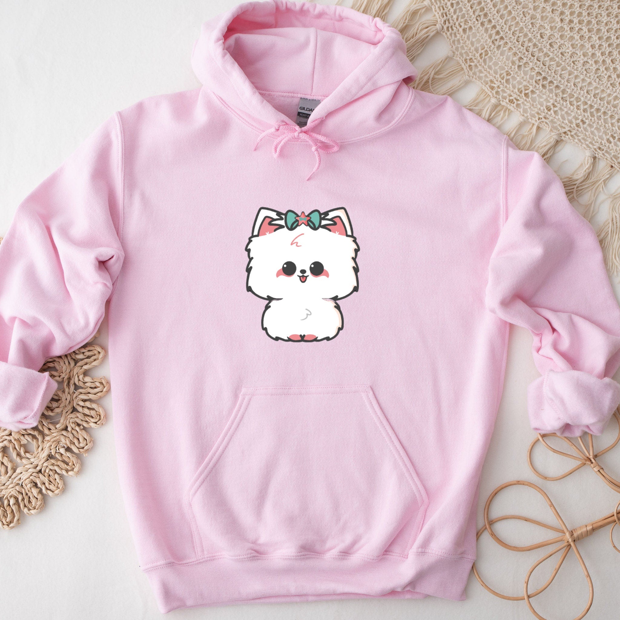 a pink sweatshirt with a picture of a dog on it