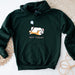a green sweatshirt with a picture of a dog sleeping on it