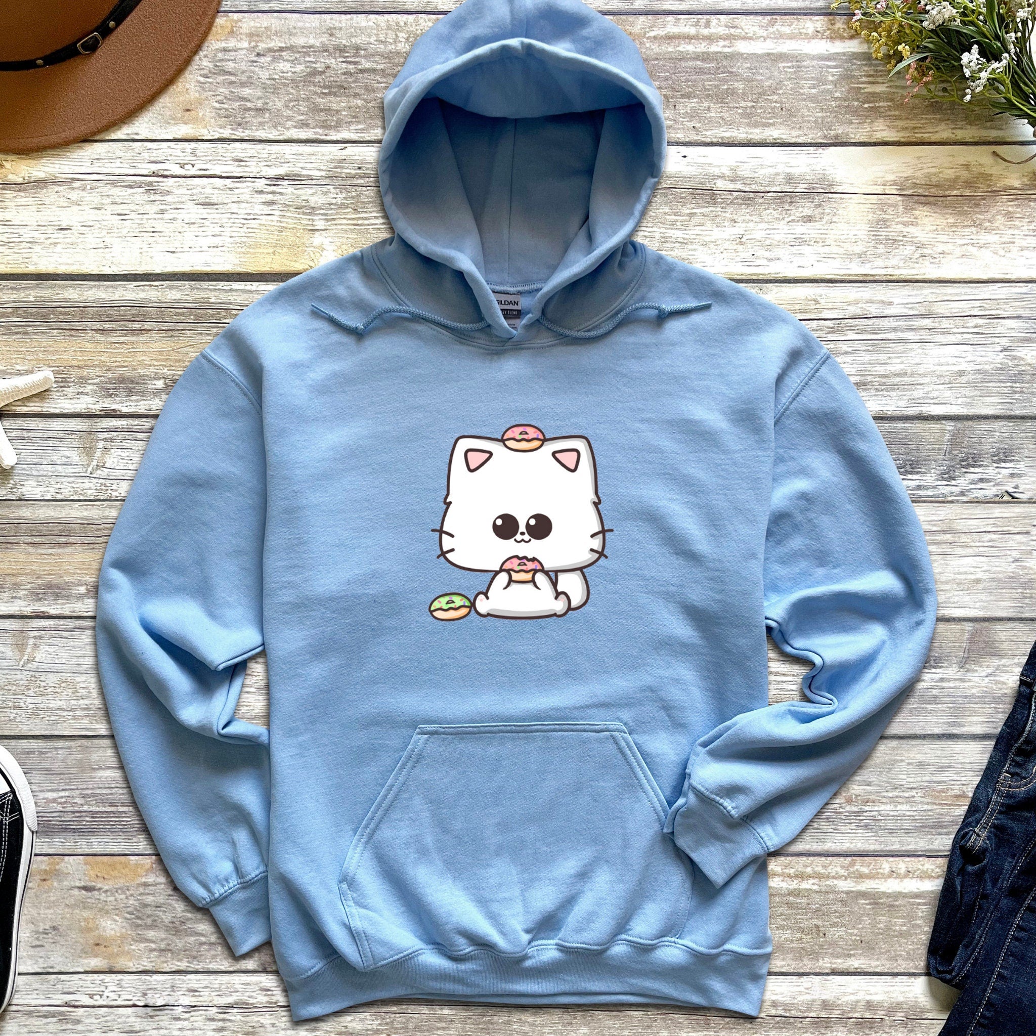 a blue hoodie with a white cat on it