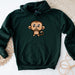 a green sweatshirt with a cartoon monkey on it