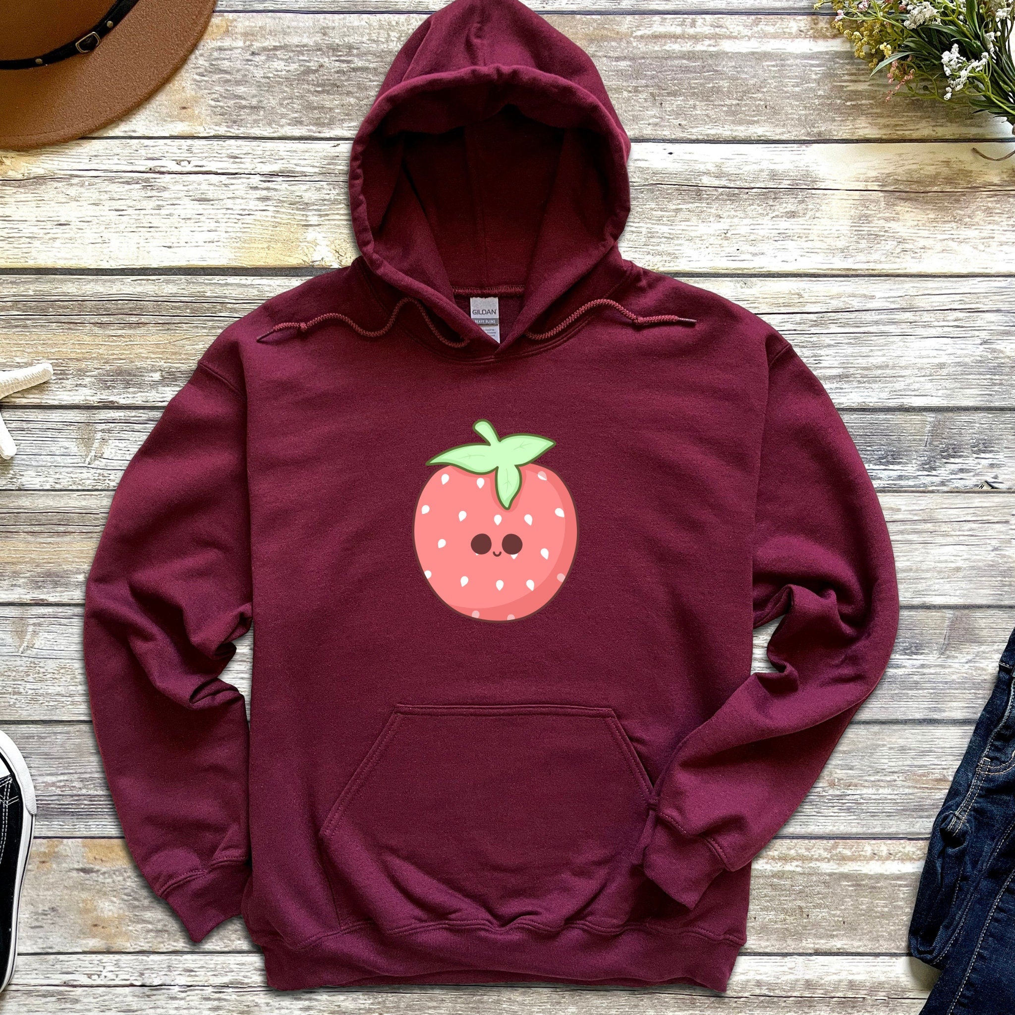 a maroon hoodie with a strawberry on it