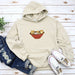 a sweatshirt with a picture of three cats in a bowl on it