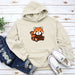 a white hoodie with a red panda on it