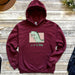 a red hoodie with a green dinosaur on it
