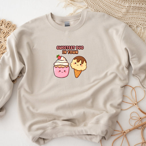 a sweater with a picture of a cupcake and a donut on it