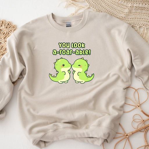 a sweater with two green birds on it