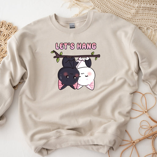 a sweatshirt with a picture of two dogs hanging on a branch