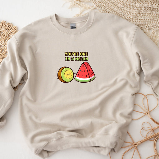 a sweater with a watermelon and kiwi on it