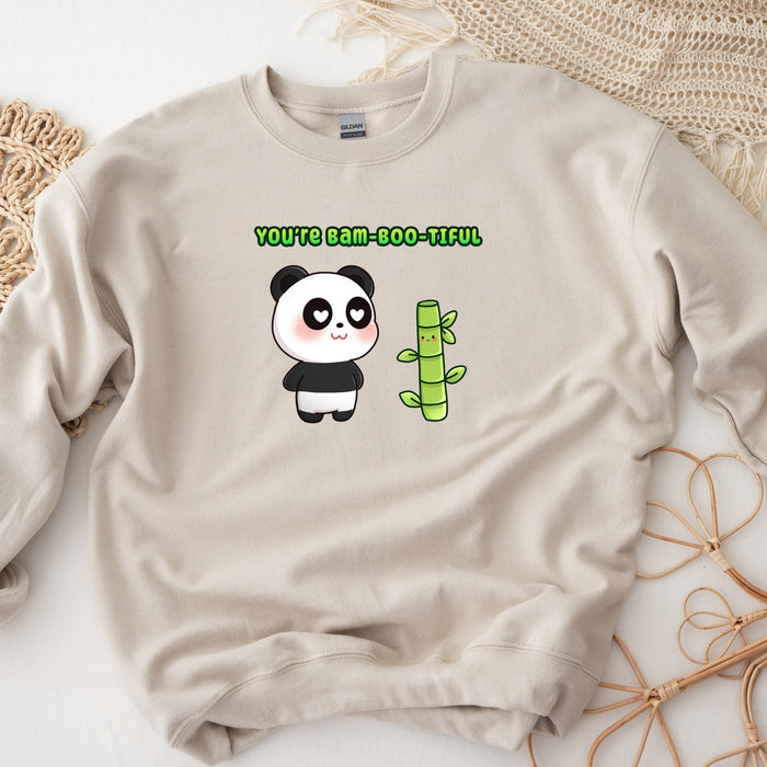 a sweater with a panda holding a bamboo stick