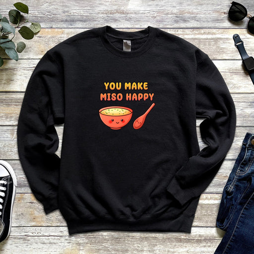 a black sweatshirt with a spoon and a bowl of soup on it