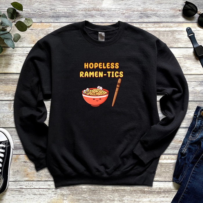 a black sweatshirt with a bowl of ramen - tics on it